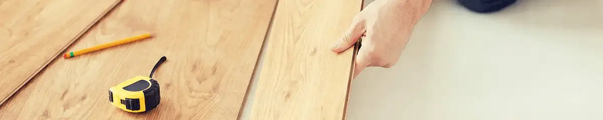 A professional installing wood flooring in San Antonio, TX