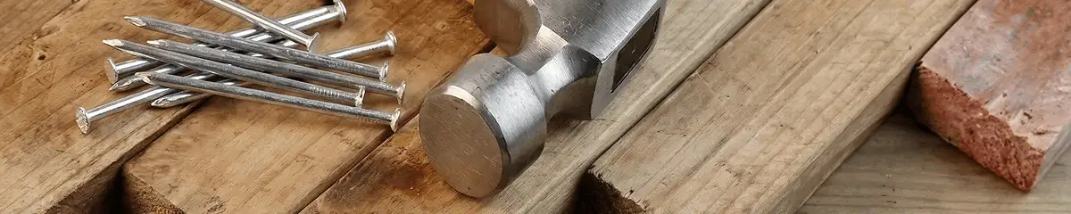 Hammer and nails on hardwood flooring boards in San Antonio, TX
