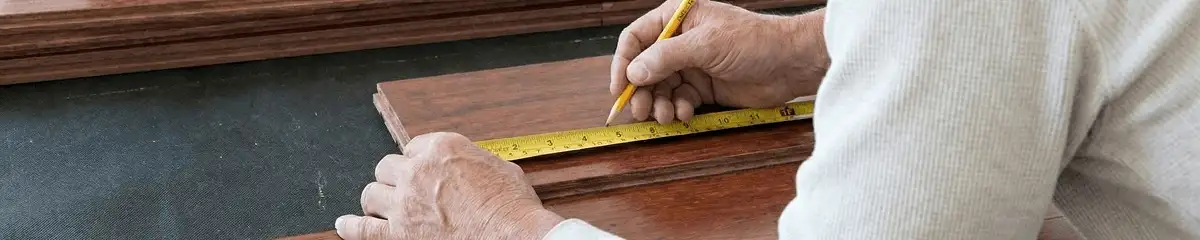 A professional installing wood flooring in San Antonio, TX